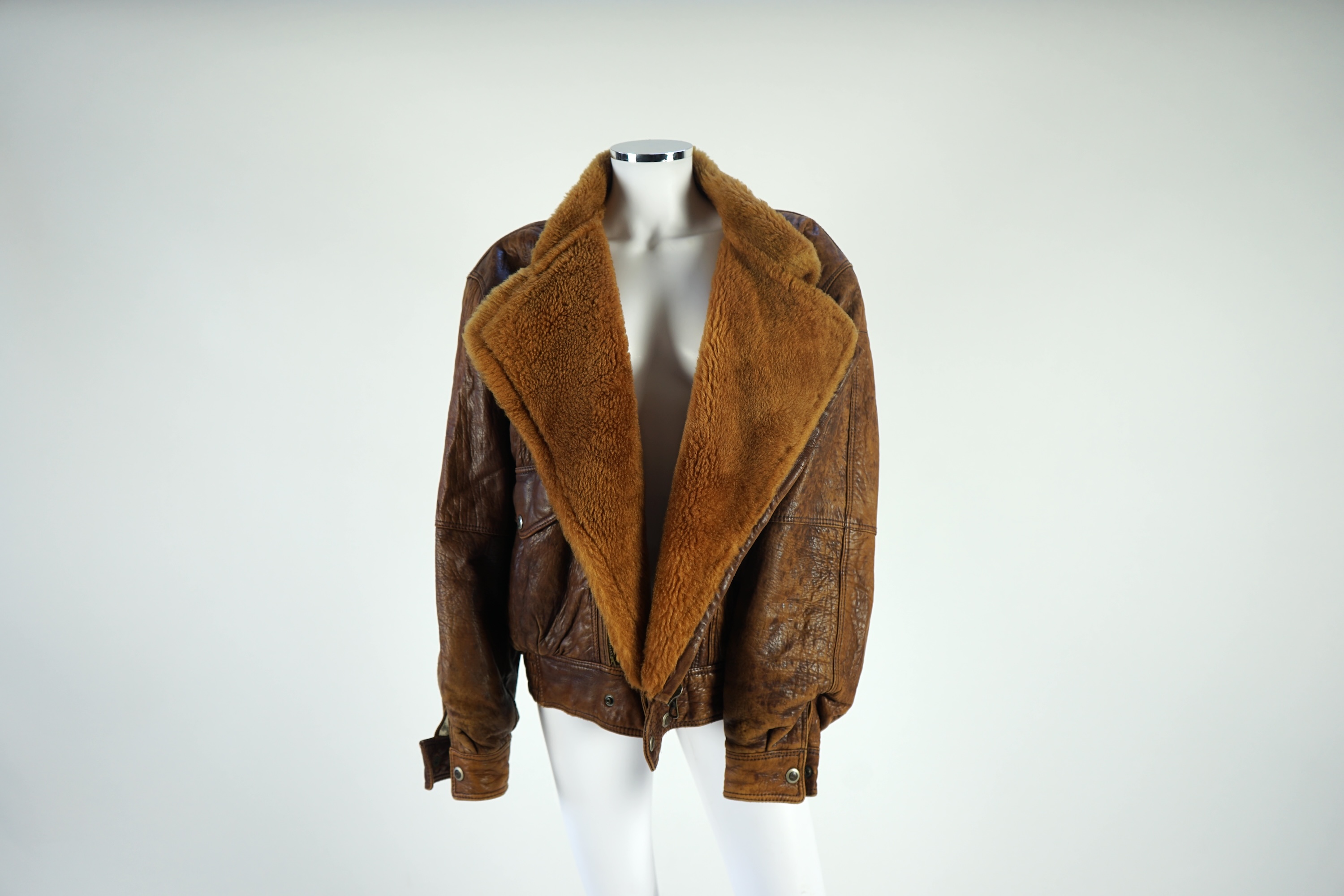 A gentleman's vintage brown leather bomber jacket made by The King, size unknown.